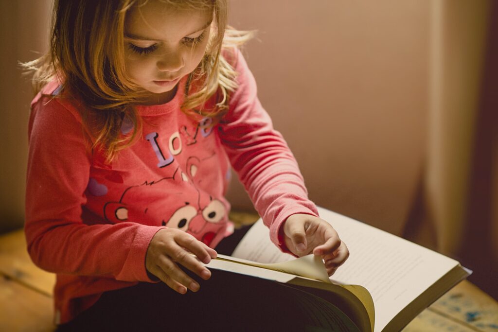 Young girl writing in gratitude journal for kids