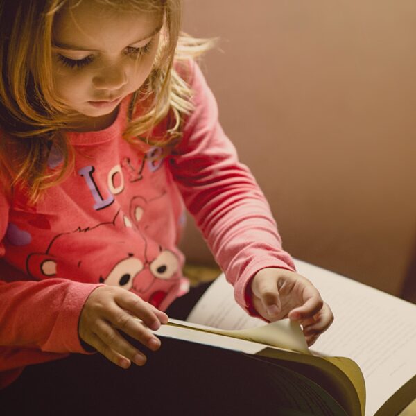 Young girl writing in gratitude journal for kids